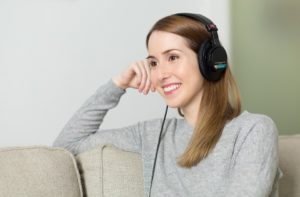 girl smiling wearing black headphones